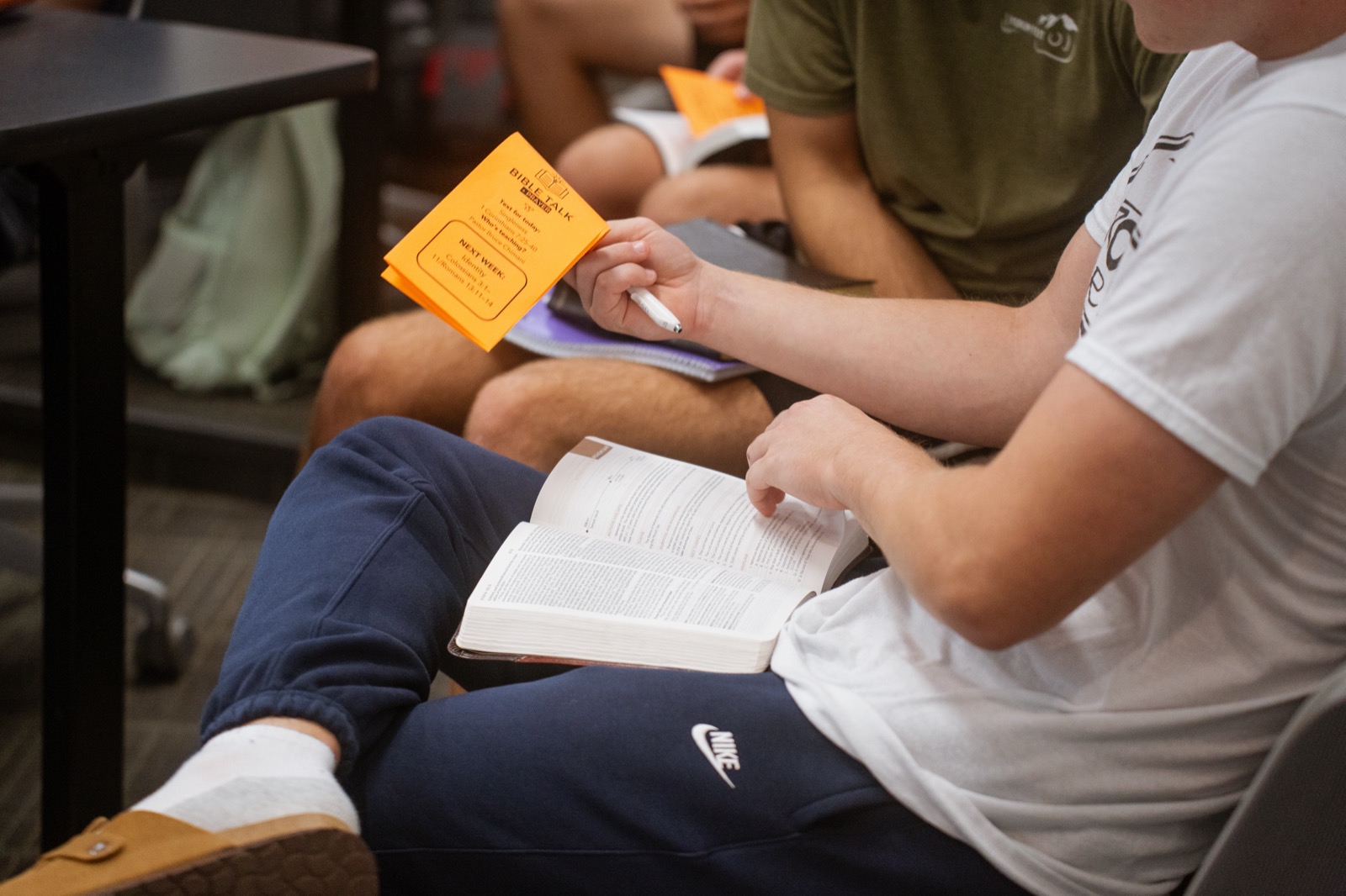A student following along in the Bible during Bible Talk and Prayer