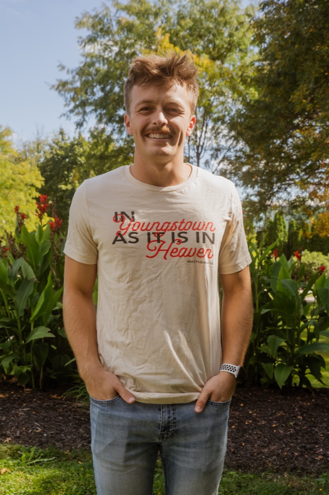 Student wearing an "In Youngstown As It Is In Heaven" t-shirt